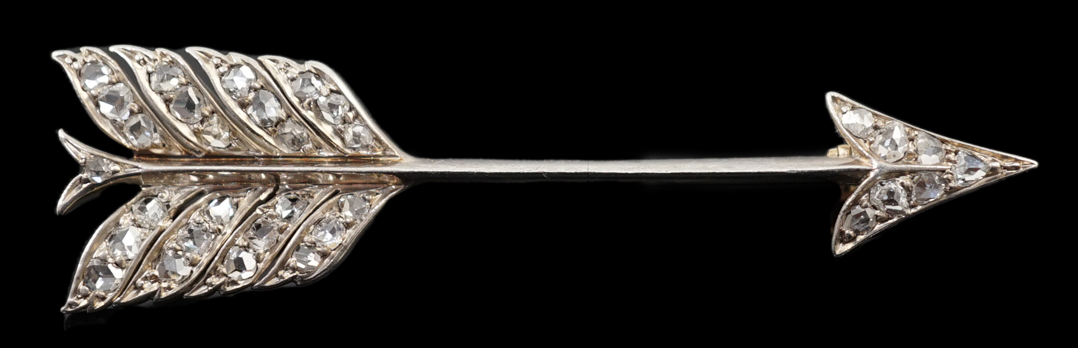 An early 20th century gold, platinum and rose cut diamond cluster set arrow brooch